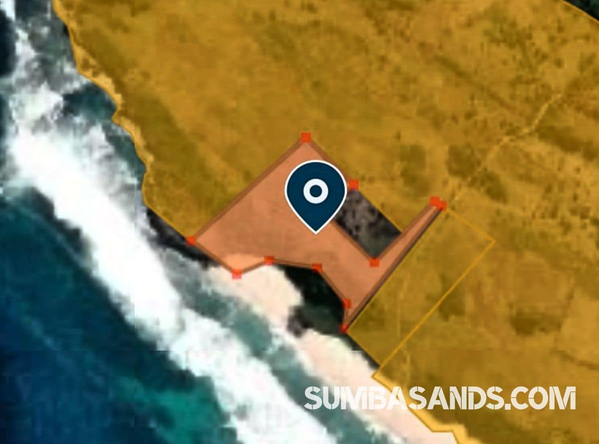 A panoramic aerial view of the Waibuku Private Beach Estate. The image captures 3.4 hectares of lush green land meeting a deep white-sand beach with turquoise waters in Pannengo Ede, Southwest Sumba.