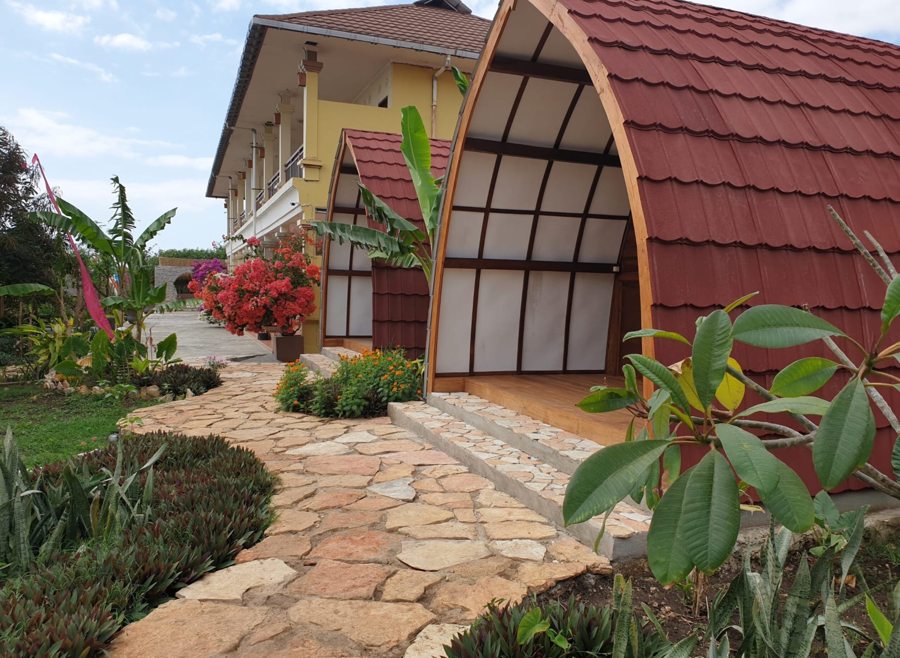 Boutique room at Mario Hotel & Cafe Sumba with traditional Indonesian design and ocean views.